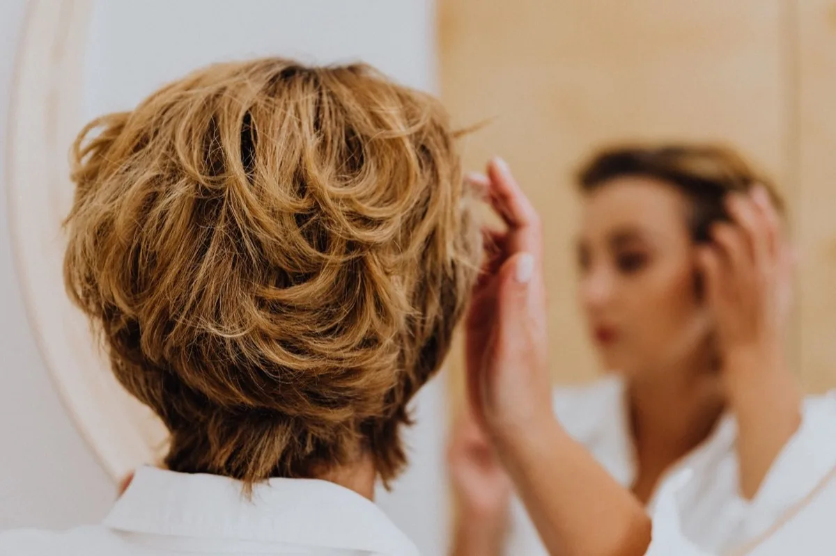 Someone looking at their reflection in a mirror